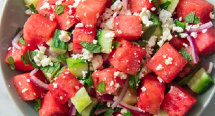 close up of Feta Watermelon Salad with onions and herbs