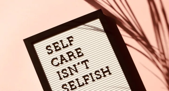 board with text "self care isn't selfish"